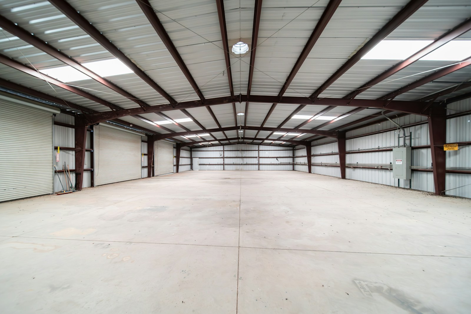 An empty modern steel warehouse with polished concrete floor